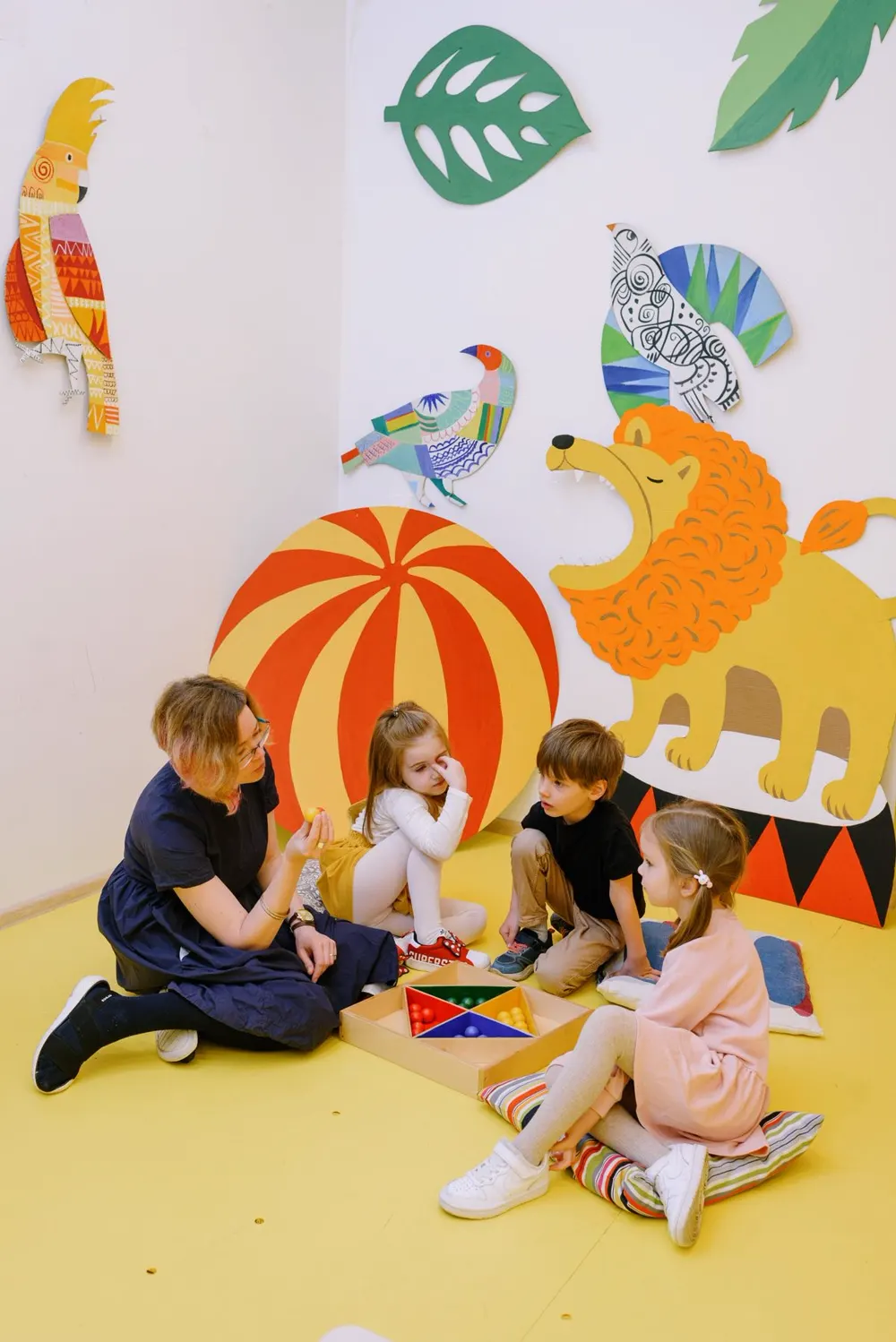 Teacher warmly playing with a preschooler in the classroom
